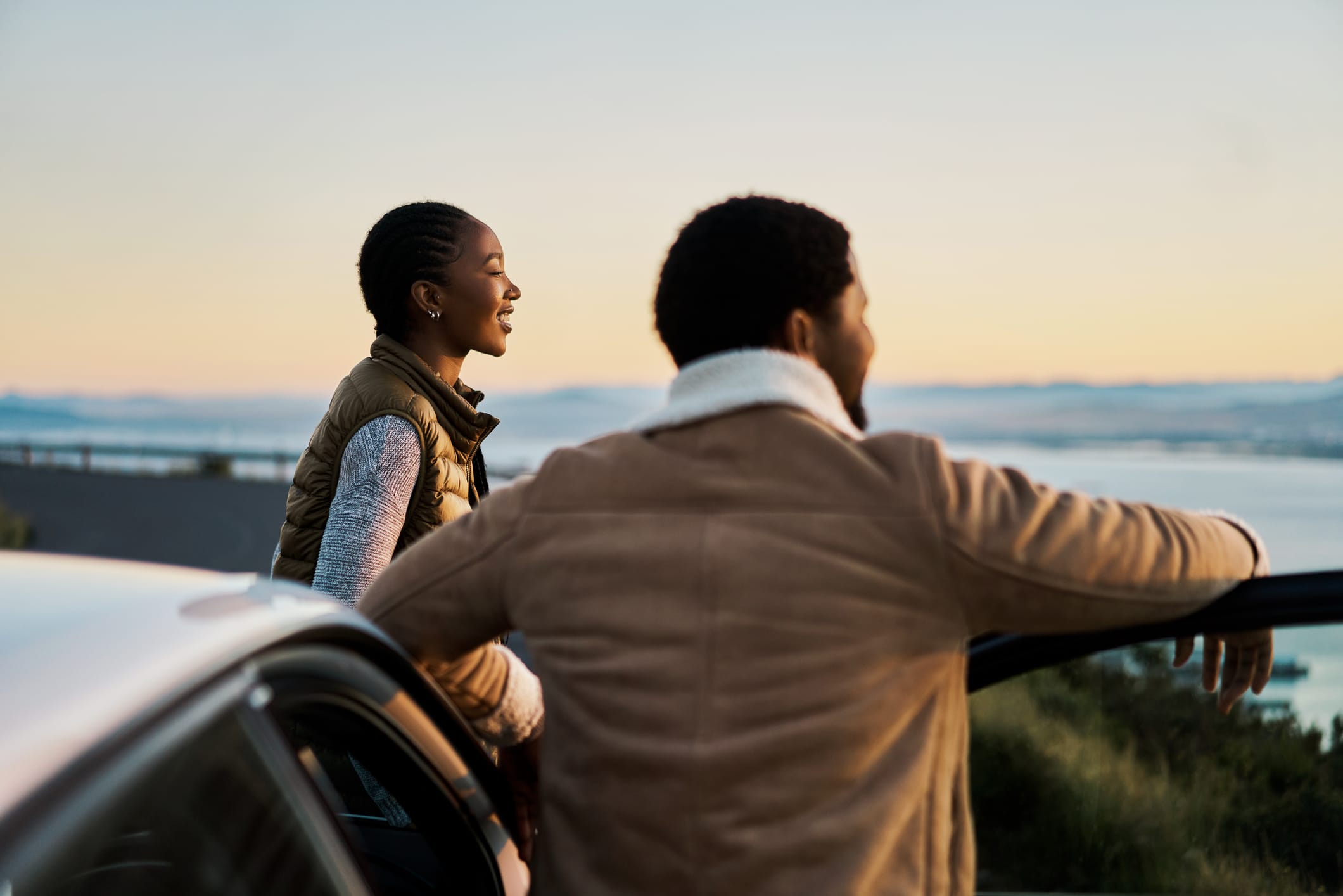 Young couple admiring the view on a road trip