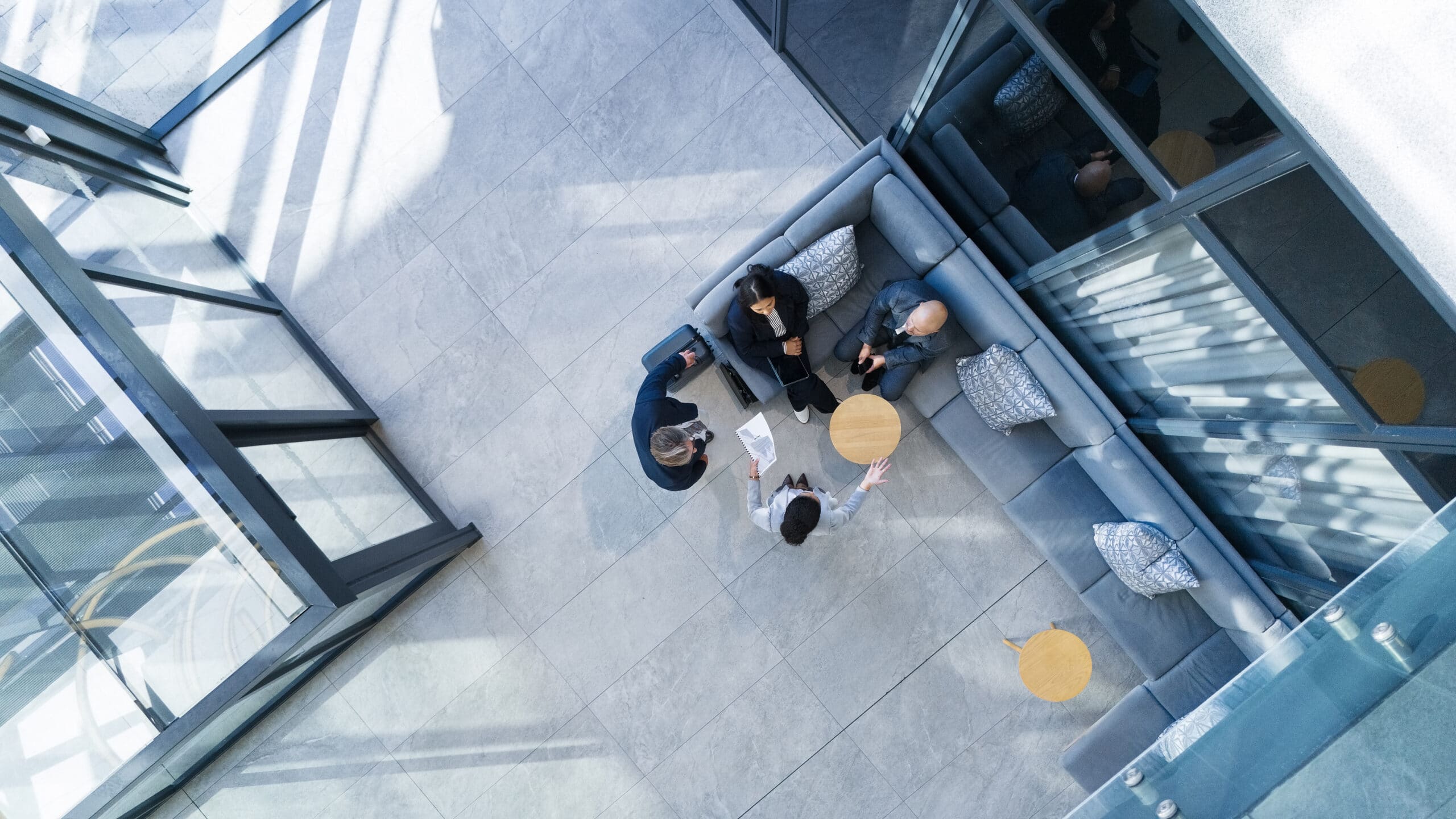 Business people from above talking around a table in an office