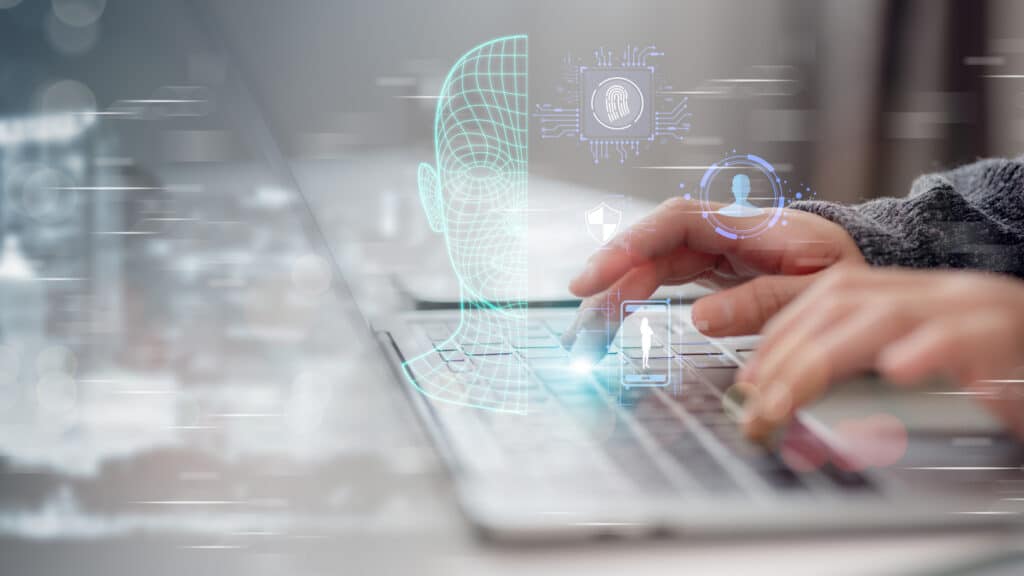 Man typing on laptop with graphics of biometric screening above