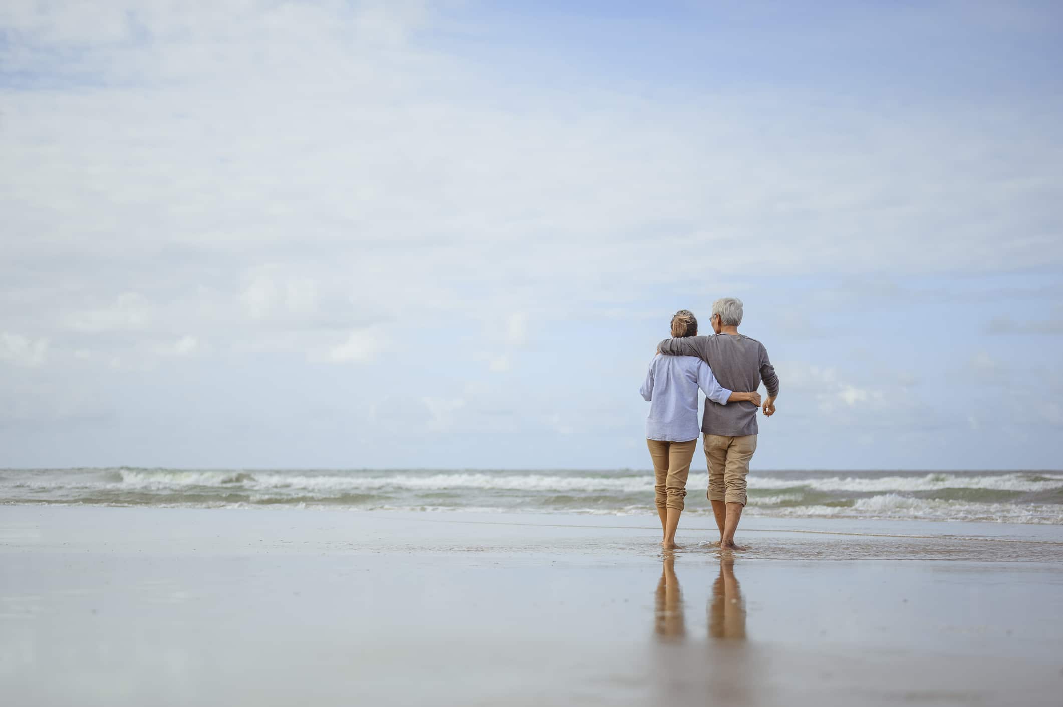 Senior couple walking on the beach