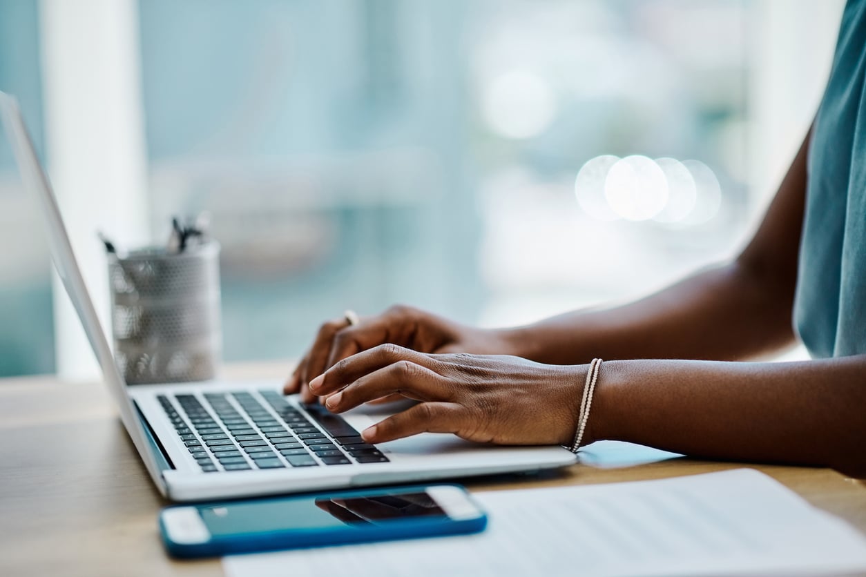 businesswoman typing on a laptop