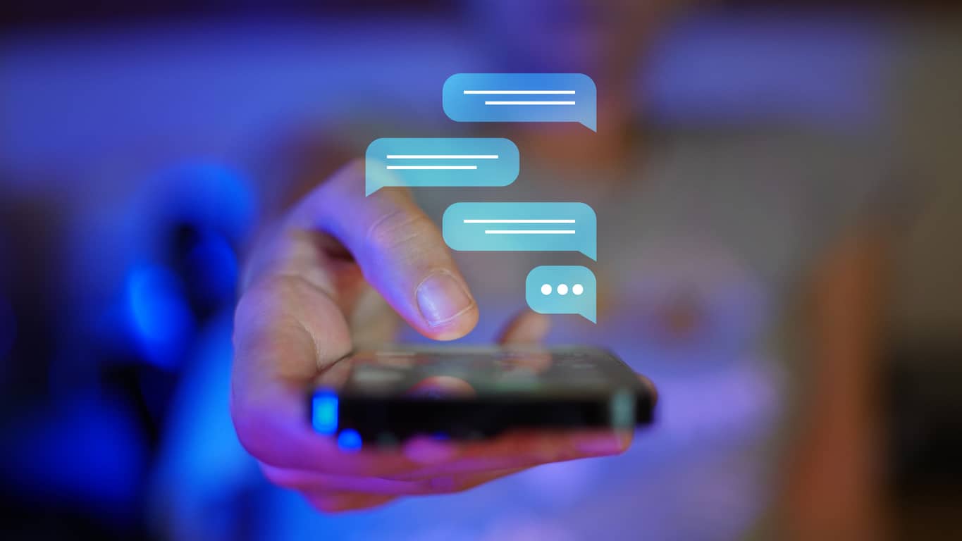 Woman hand showing a mobile phone towards camera viewpoint, digital overlay of messaging screen
